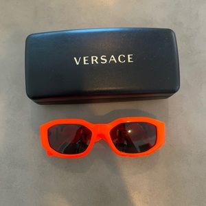 Orange never been worn Versace sunglasses. Unisex